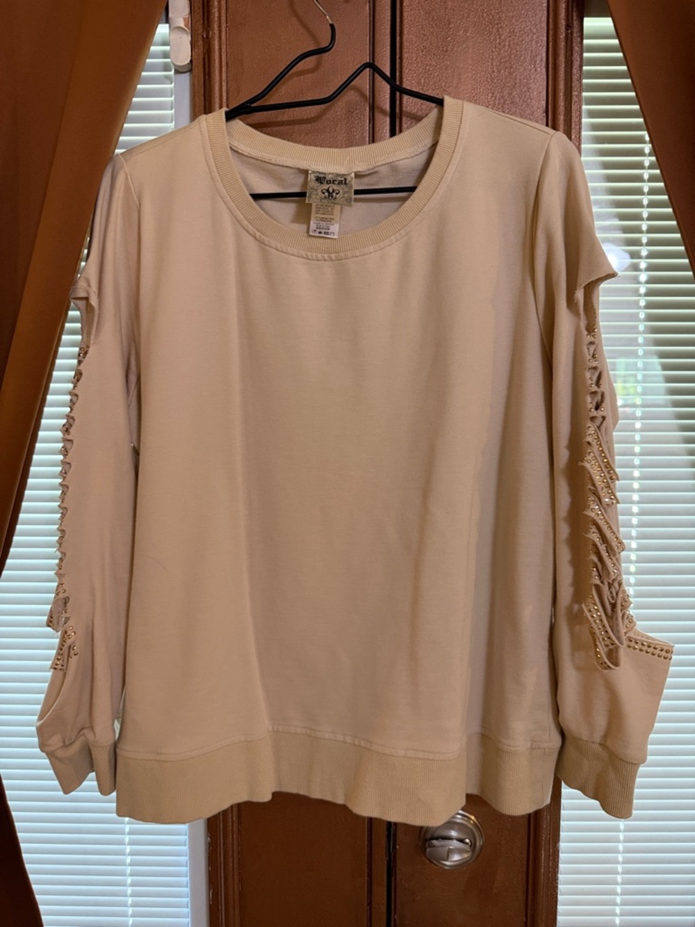 Top by Vocal, long sleeves with open areas loaded with sparkles. Size medium.